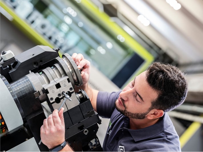 Skilled tube bending operator checks the tightening of some equipment components