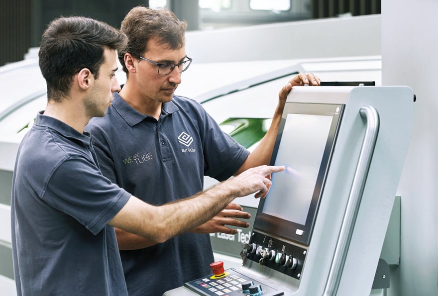 Operators at work on an LT7 tube laser cutting system